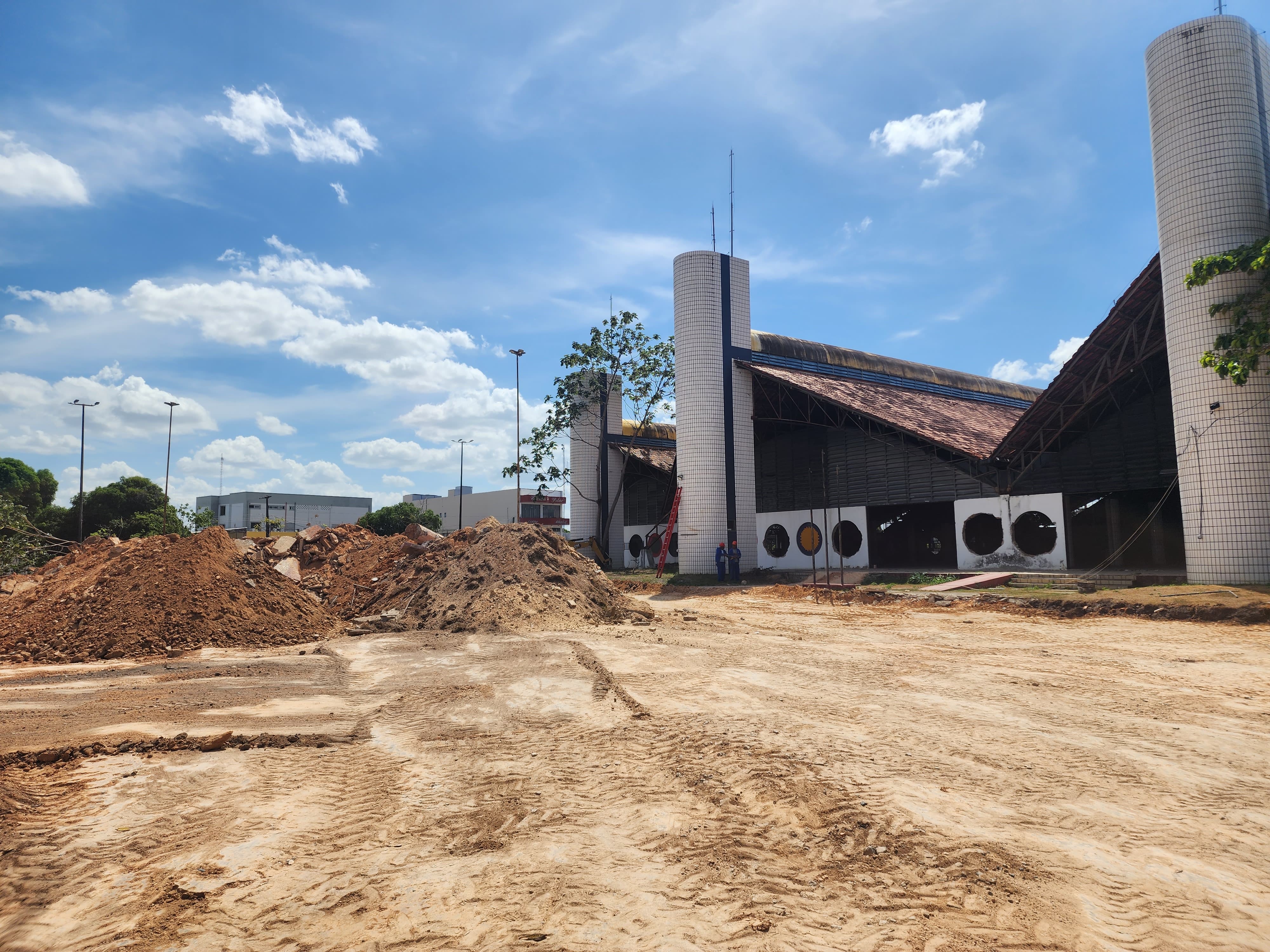 Foto colorida dos fundos do Palácio Latife Salomão em obras. No lado esquerdo da foto há montes de areia que serão usados para fazer a obra.