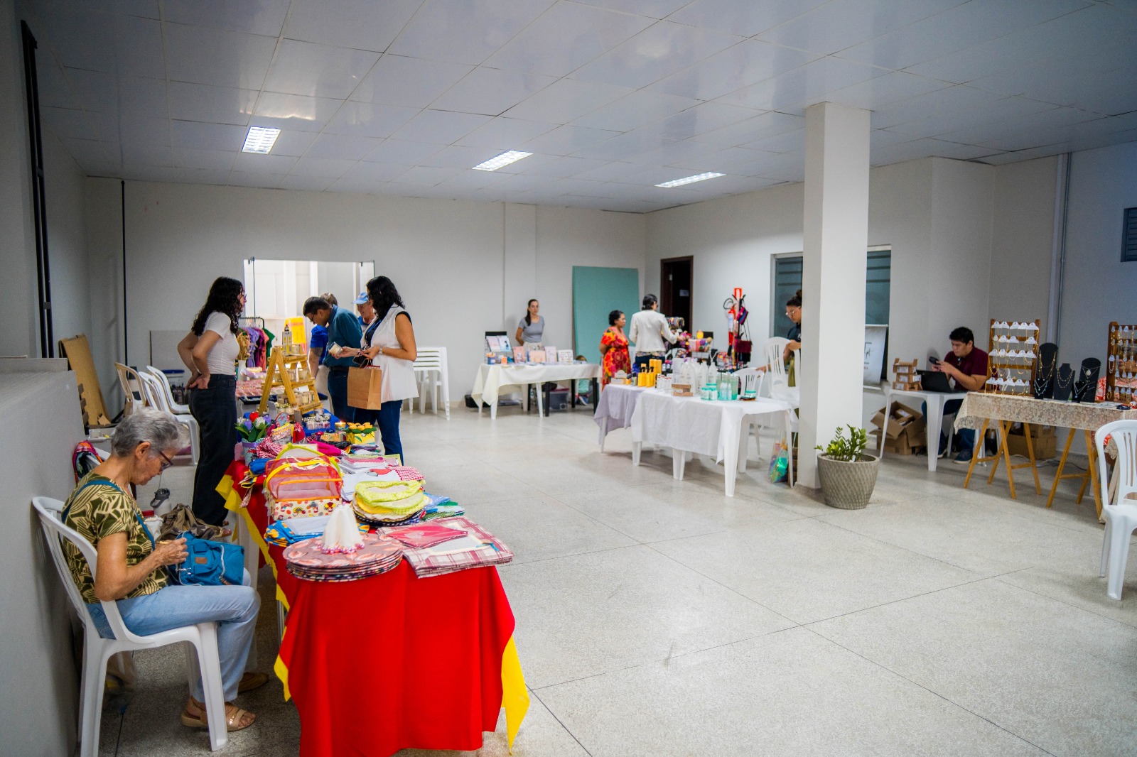 Imagem colorida contém a imagem de uma feirinha de artesanato do TJRR que ocorreu no subsolo do Palácio da Justiça. Na imagem é possivel ver diversas pessoas comprando nas exposições e vendedores sentados ou interagindo com público. Imagem colorida contém a imagem de uma feirinha de artesanato do TJRR que ocorreu no subsolo do Palácio da Justiça. Na imagem é possivel ver diversas pessoas comprando nas exposições e vendedores sentados ou interagindo com público.