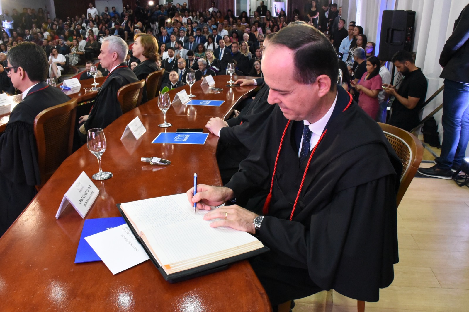 Imagem colorida mostra o diretor da Escola do Poder Judiciário (Ejurr), desembargador Cristóvão Suter, assinando o termo de posse.