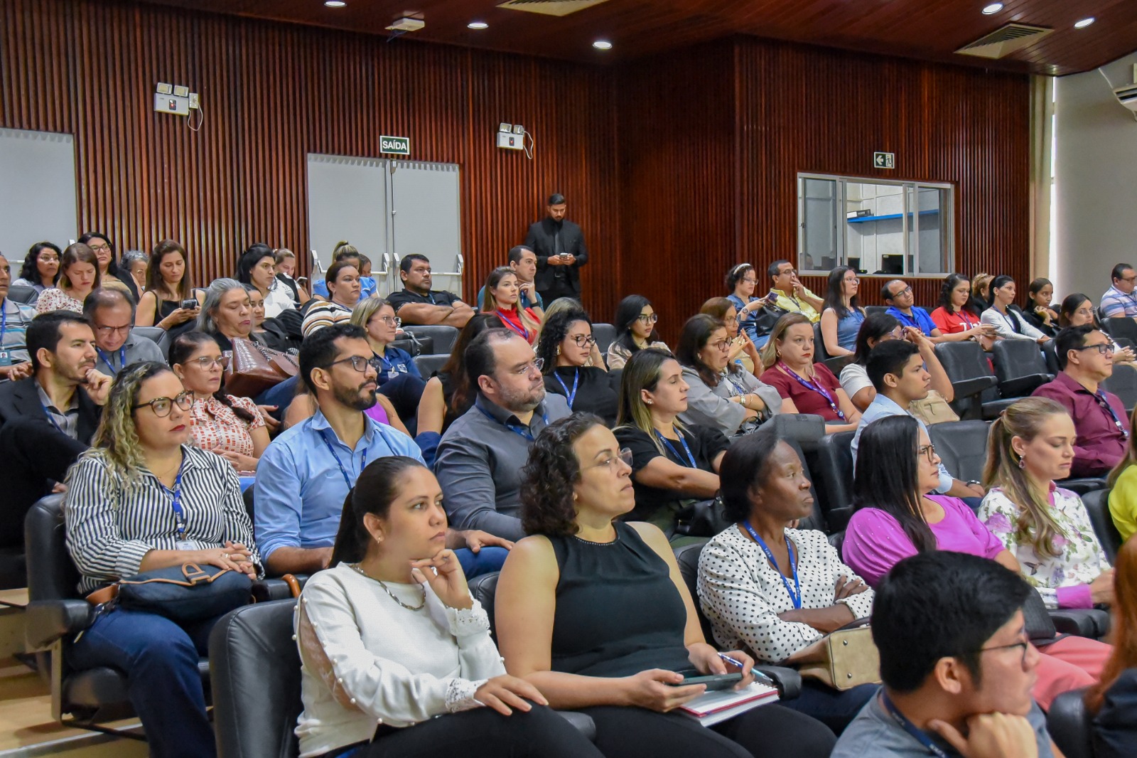 foto colorida das pessoas no auditório